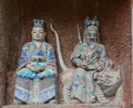 Statue of Taoist deity or god of wealth, Zhao Gongming, and his wife at Dazu Rock Carvings Royalty Free Stock Photo