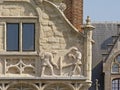 Sculpture of dockworkers, detil of an old guildhouse in Ghent