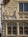 Sculpture of dockworkers, detil of an old guildhouse in Ghent