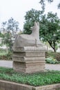 Sculpture of donkey lie on stack of books rear view in Karaalioglu park Antalya Turkey