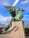 Sculpture of dragon on Dragon bridge and beautiful dramatic sky in Ljubljana, Slovenia