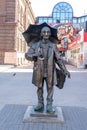 Sculpture of an elderly artist with an umbrella