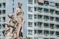 Sculpture of engineer and scholar on Zoll Bridge in Magdeburg and multistore building in background, Germany, contrast old and new Royalty Free Stock Photo