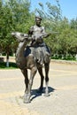 Sculpture featuring a man with a string musical instrument on a camel