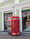 Sculpture in the form of a red telephone booth in the historical center of Omsk in summer