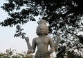 Sculpture of a four-armed Hindu deity. Mythical creature with four faces Royalty Free Stock Photo