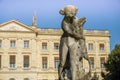 Sculpture in garden with ancient building in the background