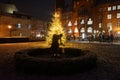 Sculpture Girl with ball in front of the lit Christmas tree in front of the Rathaus KÃÂ¶penick. Berlin, Germany