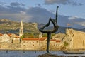 Sculpture girl dancing. Against the backdrop of the old town of Budva