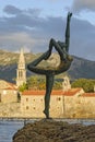 Sculpture girl dancing. Against the backdrop of the old town of Budva Royalty Free Stock Photo