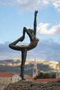 Sculpture girl dancing. Against the backdrop of the old town of Budva Royalty Free Stock Photo