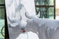 Sculpture of Glamour cow watching a mirror on a snowy winter day, close-up