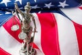 Sculpture of the goddess of justice - Themis against the background of the national flag of the United States of America. Justice Royalty Free Stock Photo