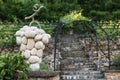 Sculpture of grapes made of stone on the background of a vineyard