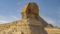 Sculpture of the great Sphinx against the blue sky and the pyramid of Menkaure