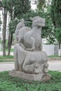 Sculpture of happy donkey lying on back of kneeling man rear view in Karaalioglu park Antalya Turkey