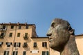 sculpture of head in historical mediterranean city,