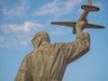 Sculpture in honor of the aircraft industry. Man with an airplane. Monument in the park