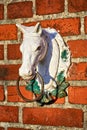 Sculpture Horse head on brick wall