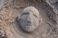 Sculpture of a human face by sand