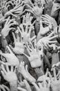 Sculpture of hundreds outreaching hands. White Temple, Chiang R