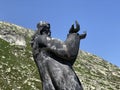 The sculpture il ``viandante`` the Wanderer, sculpture by Pedro Pedrazzini on the Gotthard pass Gotthardpass in the Swiss Alps