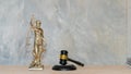 Sculpture justice bronze lady and book and hammer with laptop Blind justice symbol on concept metal sculpture. female judge Royalty Free Stock Photo