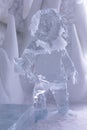 Sculpture of life-size traditional Inuit fisherman holding fish in a hall of the seasonal Ice Hotel