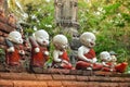 Sculpture of little monks with bowls at the buddhists temple in Ayutthaya Royalty Free Stock Photo