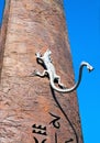 Sculpture of a lizard with another head on its tail, the detail of the sundial in Florence