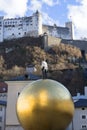 Sculpture of a man on a golden sphere by Stephan Balkenhol on Kapitelplatz, Austria, Salzburg