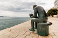 Sculpture of a man holding a sea shell