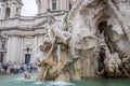 Sculpture marble statue of a lion and a man on the fountain of the four rivers in Piazza Navona in Rome, capital of Italy, as well Royalty Free Stock Photo