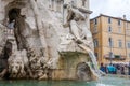 Sculpture marble statue of a lion and a man on the fountain of the four rivers in Piazza Navona in Rome, capital of Italy, as well Royalty Free Stock Photo