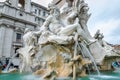 Sculpture marble statue of a lion and a man on the fountain of the four rivers in Piazza Navona in Rome, capital of Italy, as well