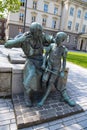 Statue in Dusseldorf, bronze monument blacksmith with boy