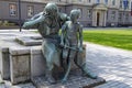 Statue in Dusseldorf, bronze monument blacksmith with boy