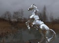 Sculpture of a metallic surreal horse standing by the Lake