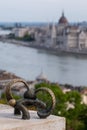 Sculpture of miniature bunny looking at Budapest with binoculars