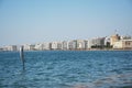 Sculpture Moon on the Shore by Pavlos Vasiliadis and waterfront of Thessaloniki with White Tower and part of Royal theatre