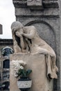 Sculpture of mourning crying woman on a grave