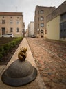 Sculpture of the Mouse with large ears sculptors S.Plotnikov and S.Yurkus performing desires on the cobbled street of the Old