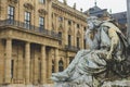 The sculpture of a musician at the base of the Franconia Fountain on Residence Square in Wurzburg, Germany