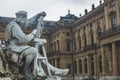 The sculpture of a painter at the base of the Franconia Fountain on Residence Square in Wurzburg, Germany