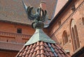 Sculpture of a pelican feeding chicks. The roof of the well on the territory of the High Knight`s Castle of the Teutonic Order. M Royalty Free Stock Photo