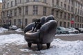 The sculpture Reader in an armchair is made in bronze. Tourist attractions of the city. Winter Time, Prague, Czech