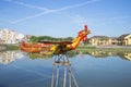 Sculpture of a rooster, flying over the Thu Bon river. Hoi An, Vietnam