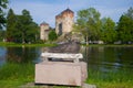 Sculpture of the Saimaan seal on the background of the medieval Olavinlinna fortress. Finland, Savonlinna