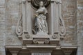 Stone sculpture of Saint Catharina above portal. Historical church in Mechelen, Belgium.