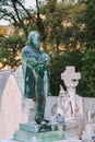Sculpture of senior man at old cemetery. stoned statue memorial at cemetery. All Saint`s Day. Copy space. Vertical. sculpture